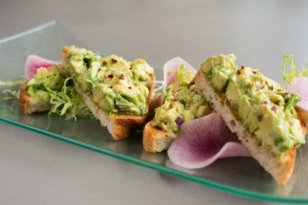 Avocado toast with smashed avocados, red onion,