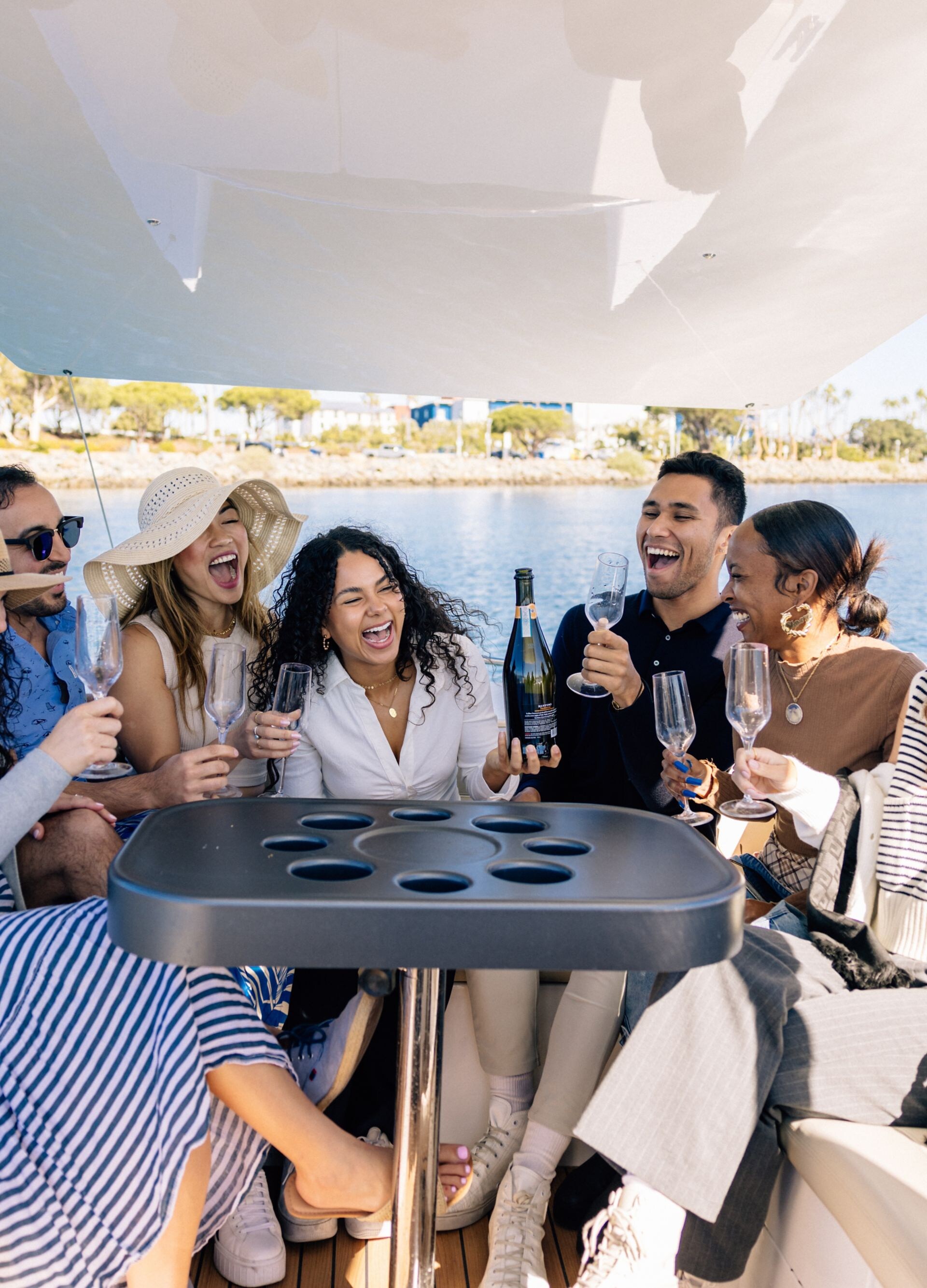 friends on boat in water with champagne