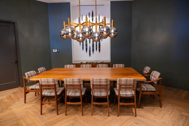 A large oak dining table with chairs surrounding
