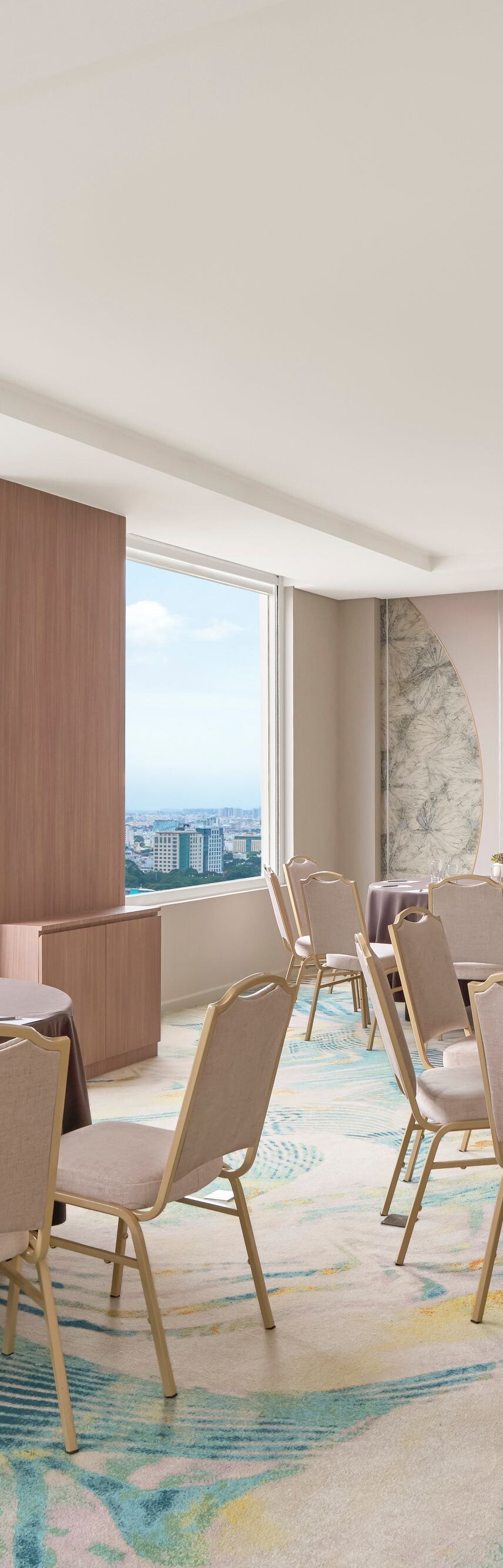 Banquet room with round tables and city views