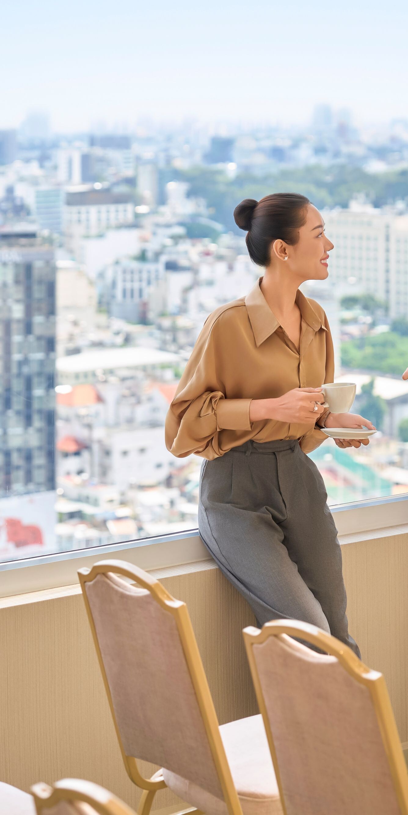 Hai vị khách đang trò chuyện bên cửa sổ phòng họp 