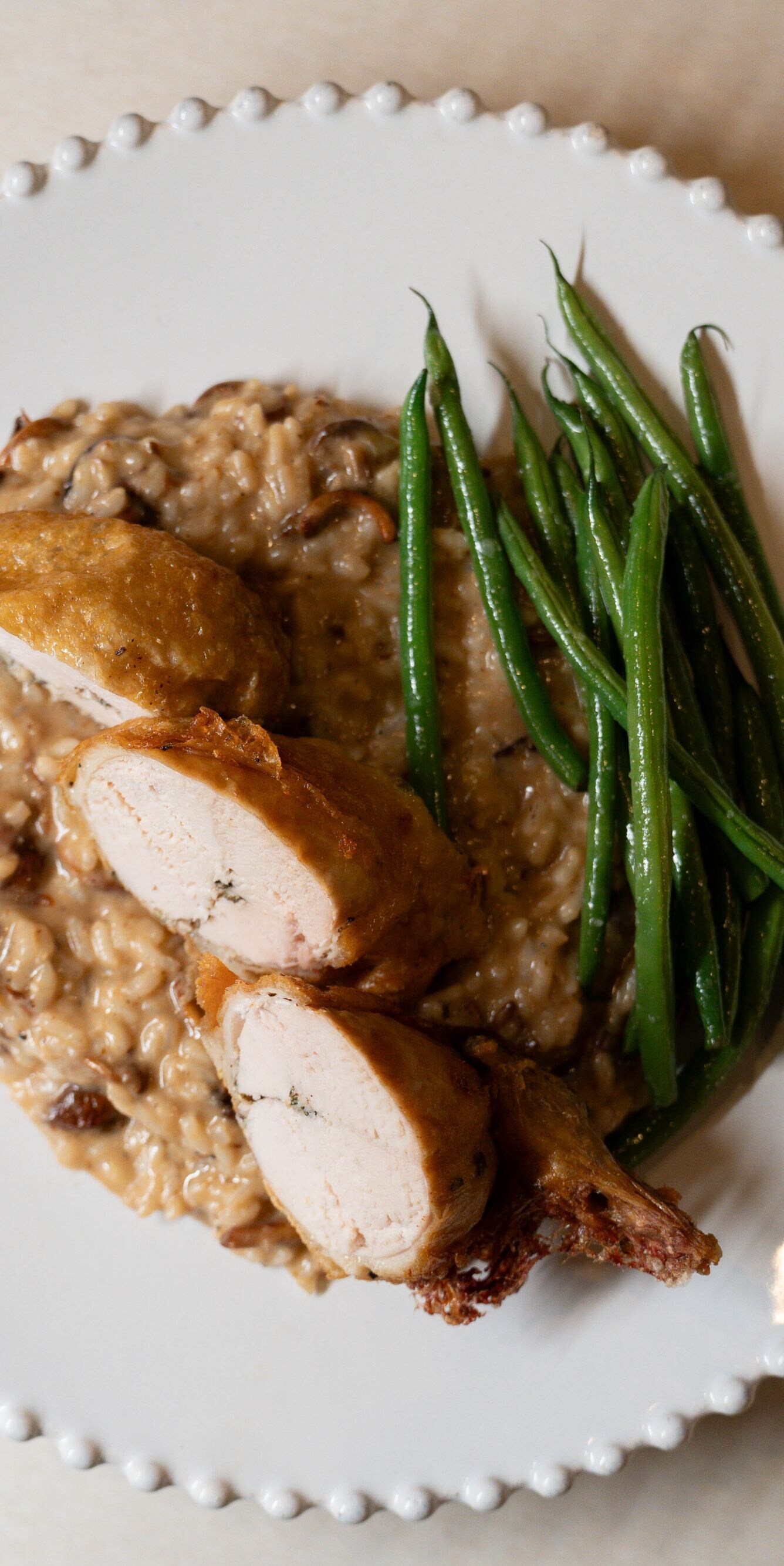 Chicken roulade with risotto and green beans