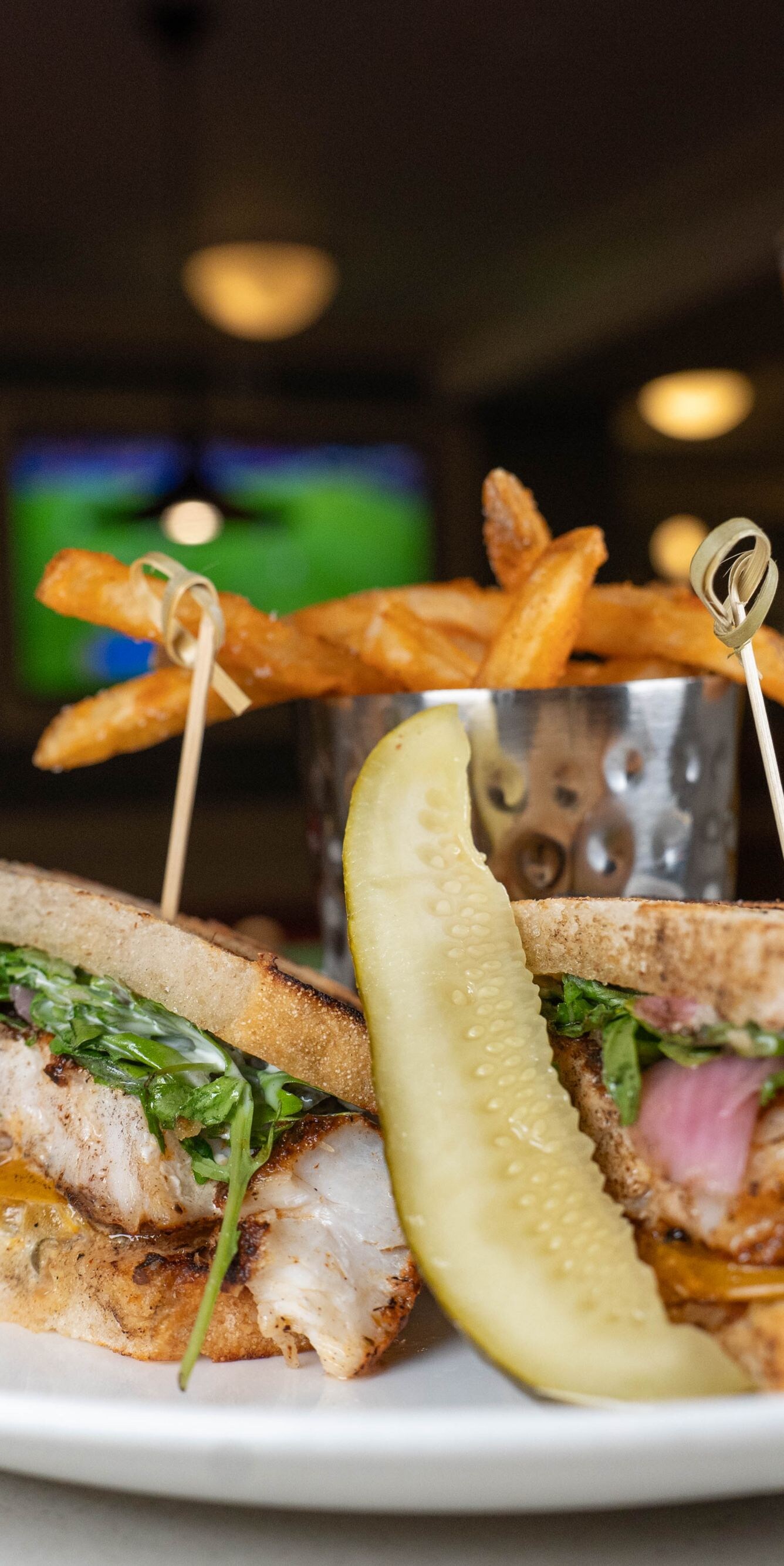 Grouper sandwich with fries and a pickle
