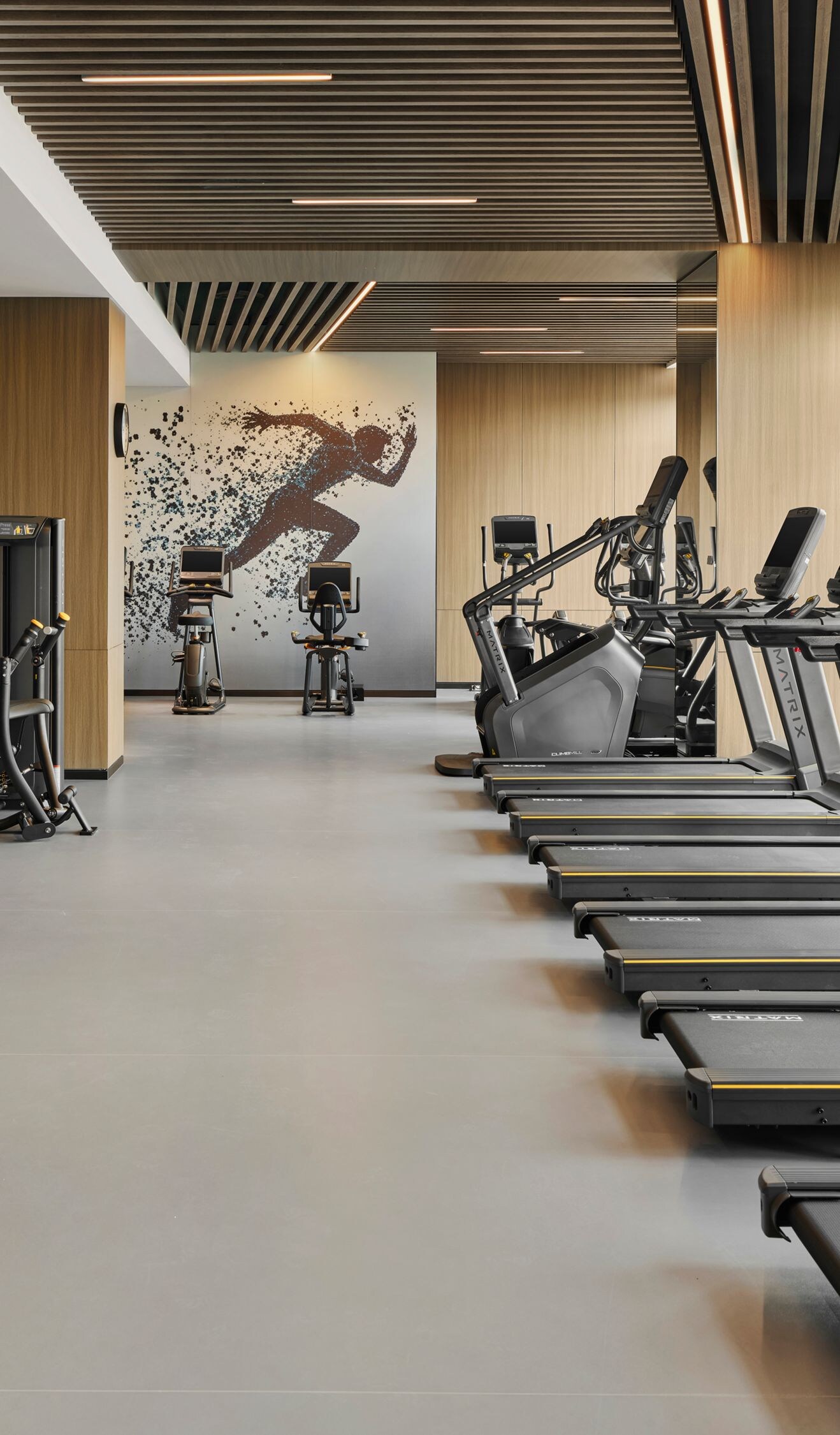 Fitness center with treadmills and city view