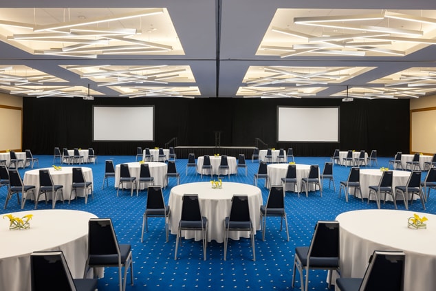 Grand Ballroom with half-round tables set up.