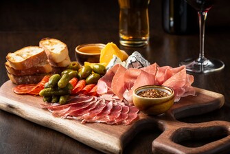 charcuterie board, meats, cheeses, olives, mustard