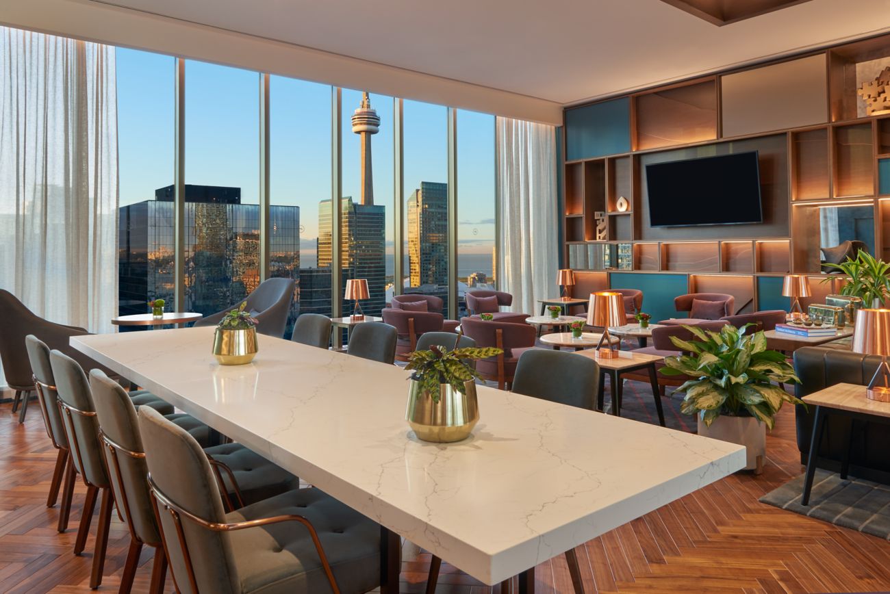 A communal table with southern view of CN Tower
