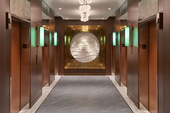 Circular wall art with elevators on either side