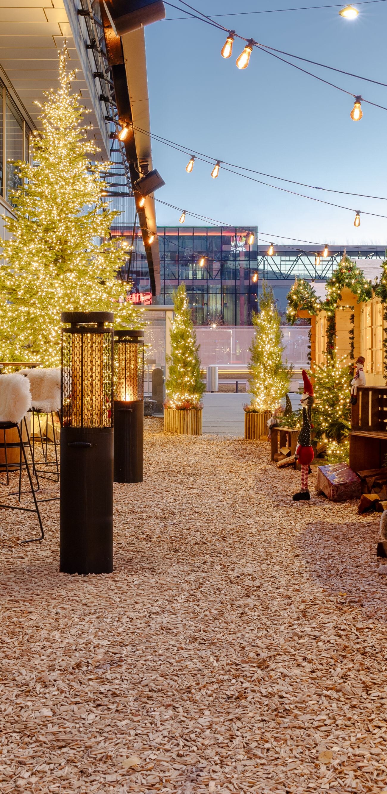 A festive outdoor terrace with wooden chalets