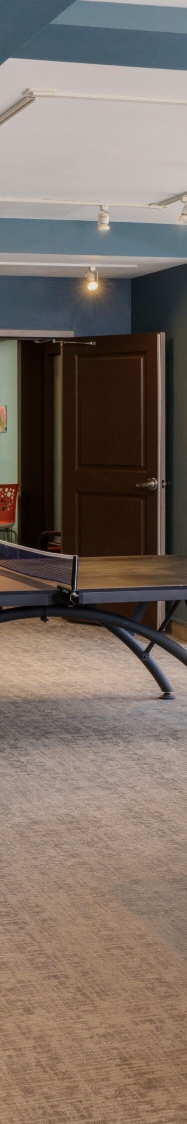 Room with billiards, table tennis, seating areas