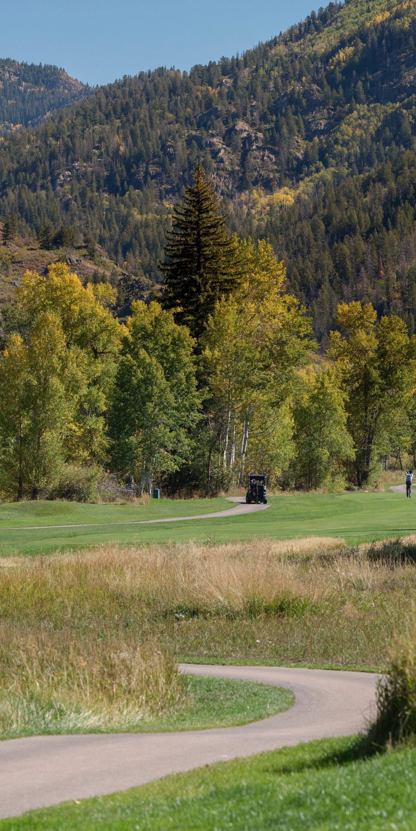 Player on golf course, view of mountains