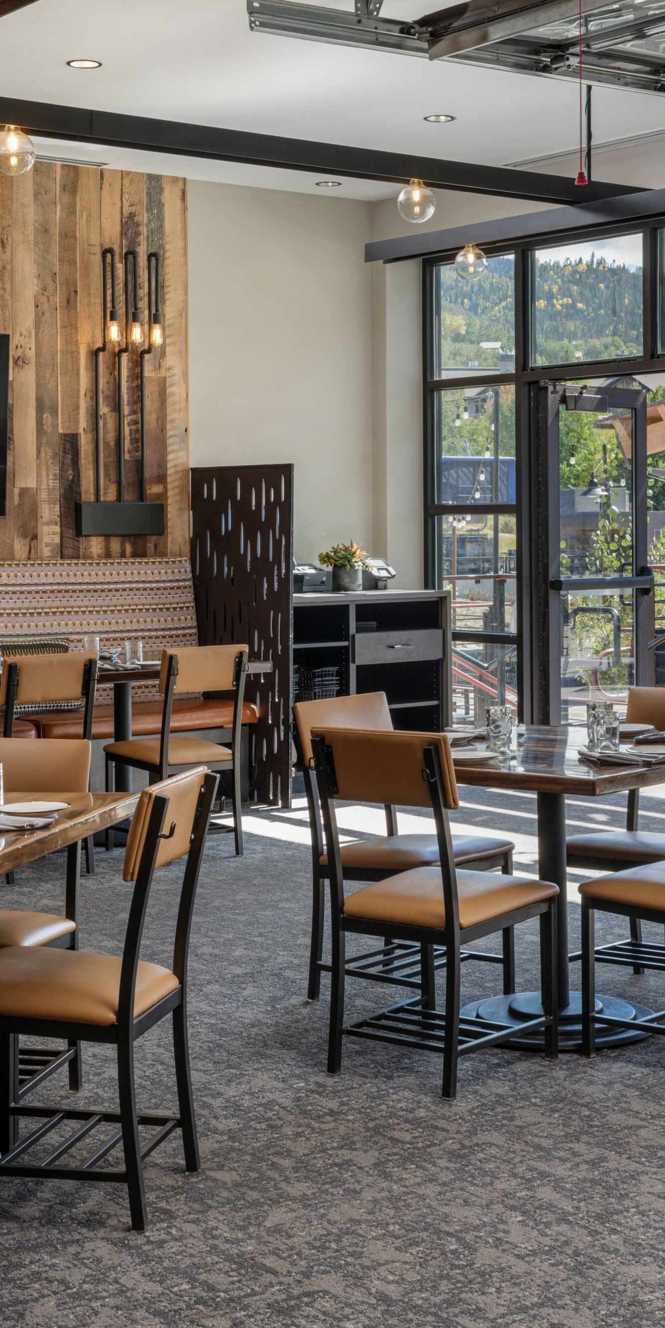 Timber & Torch indoor dining area, TV on wall