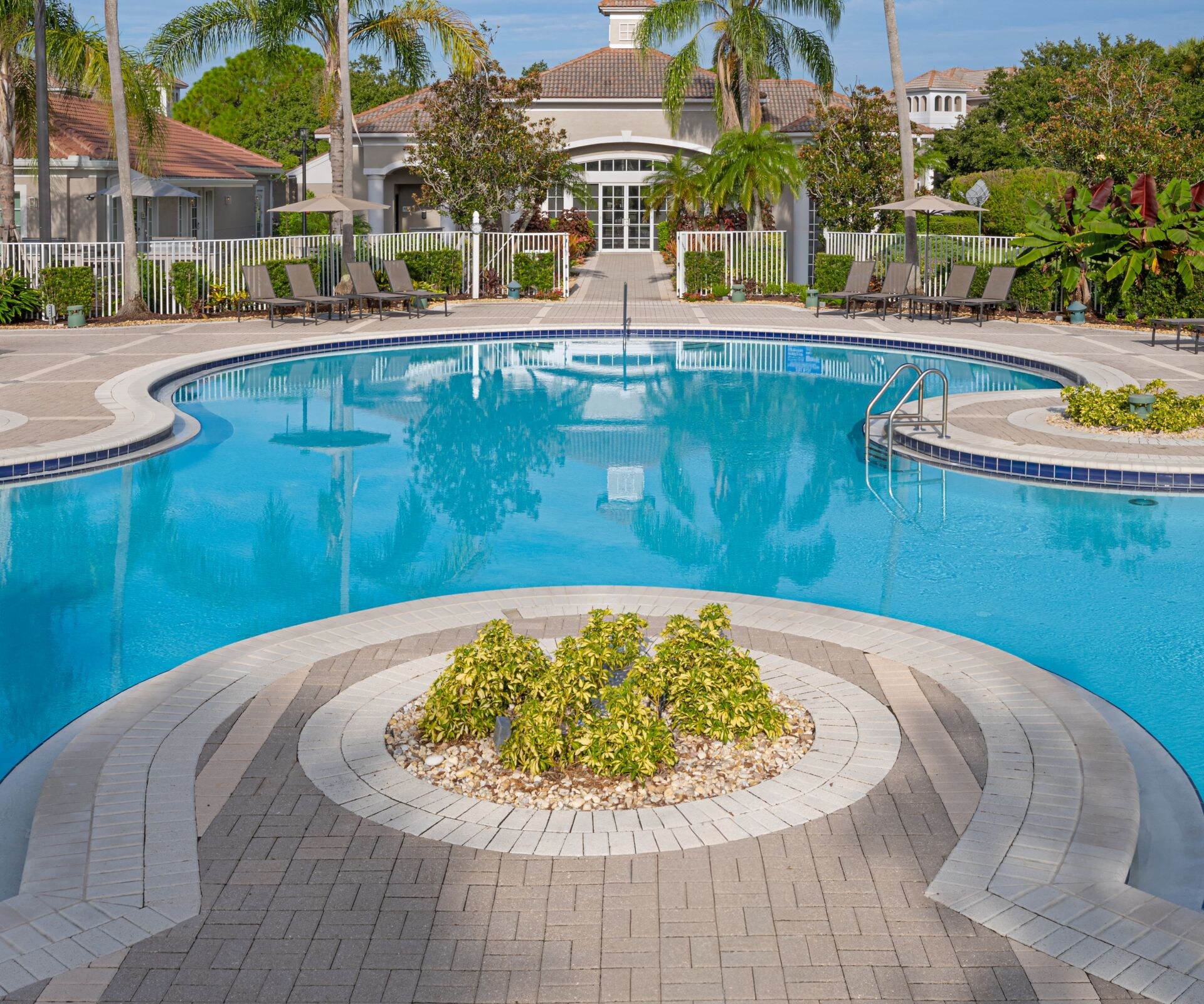 Resort pool lined with palm trees