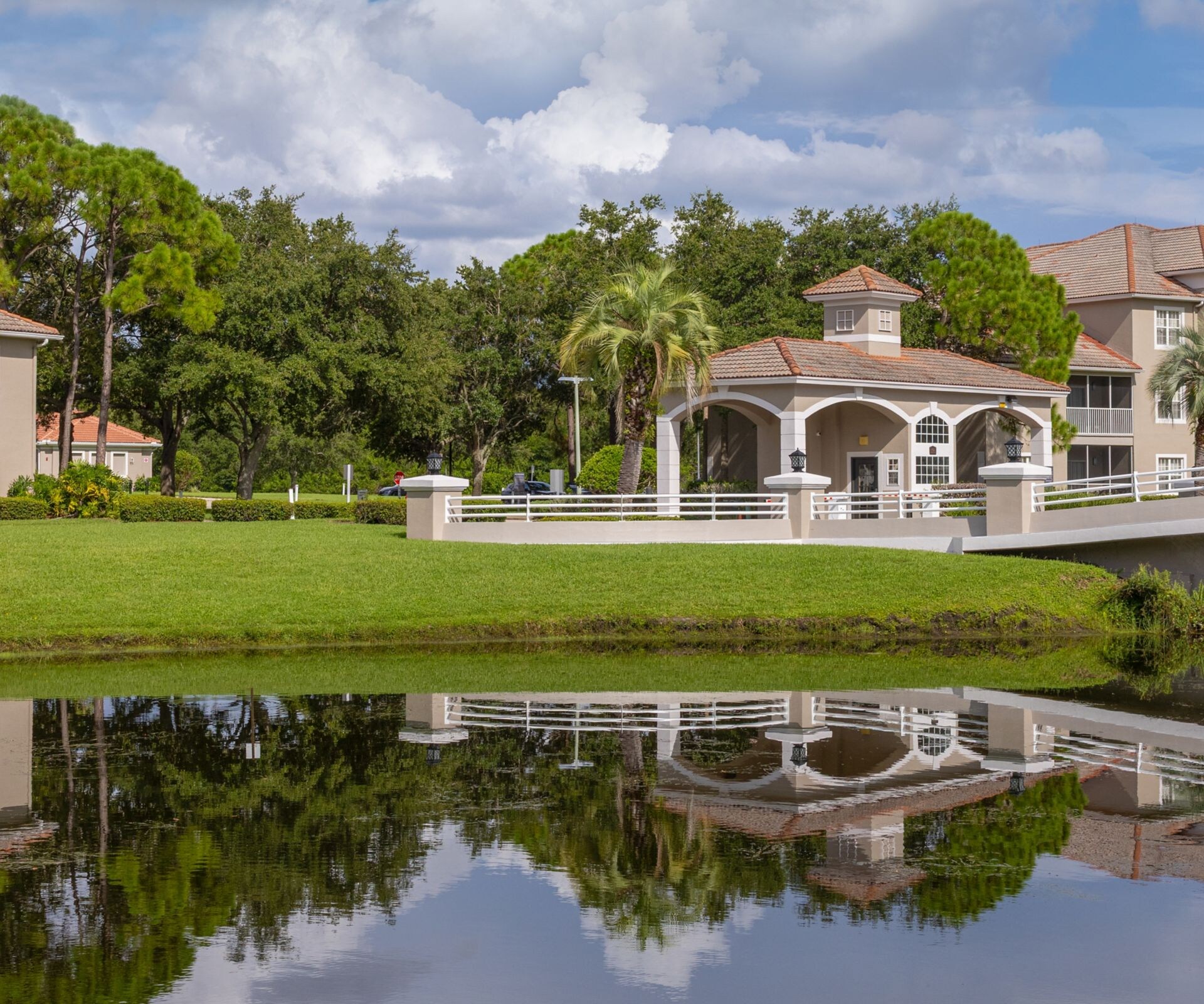 Resort grounds with pond and palm trees