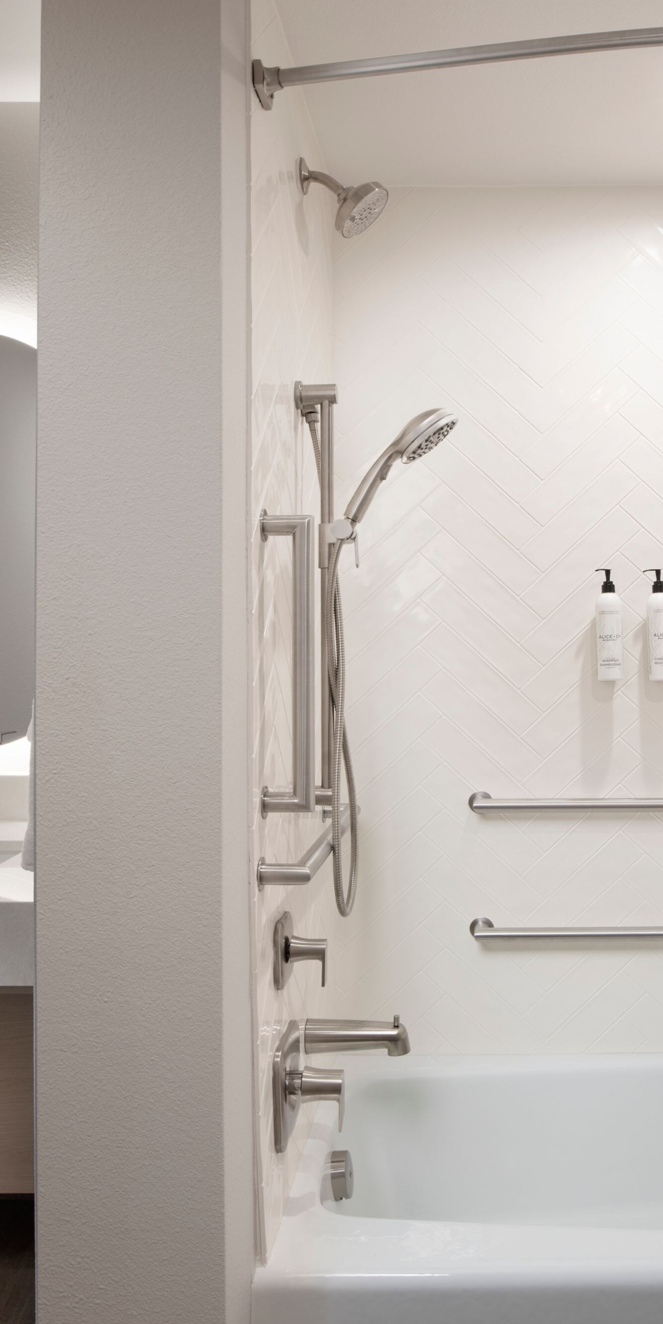 Accessible bathtub with grab bars and shower seat