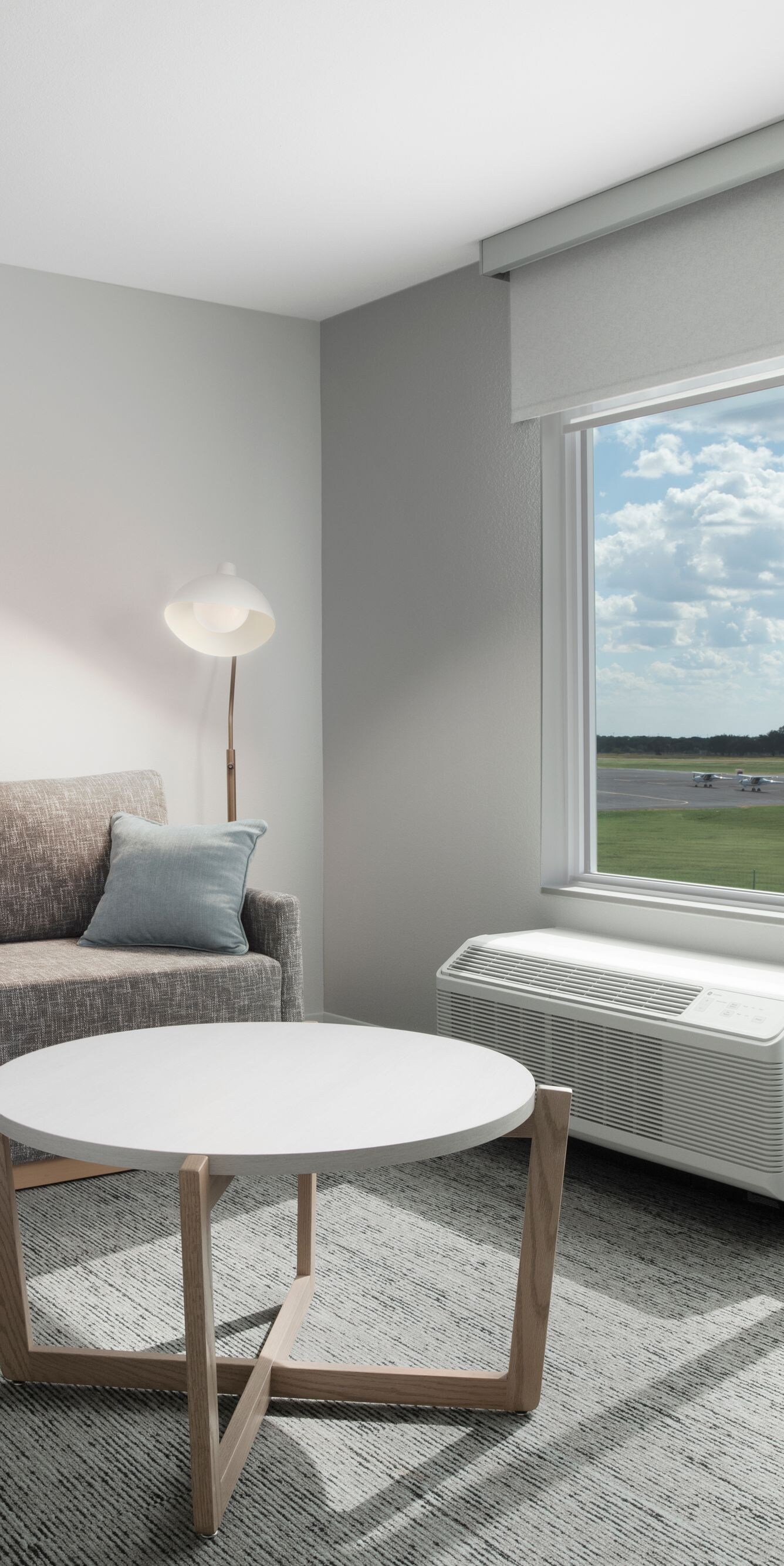 Suite living area with sofa, table & window view