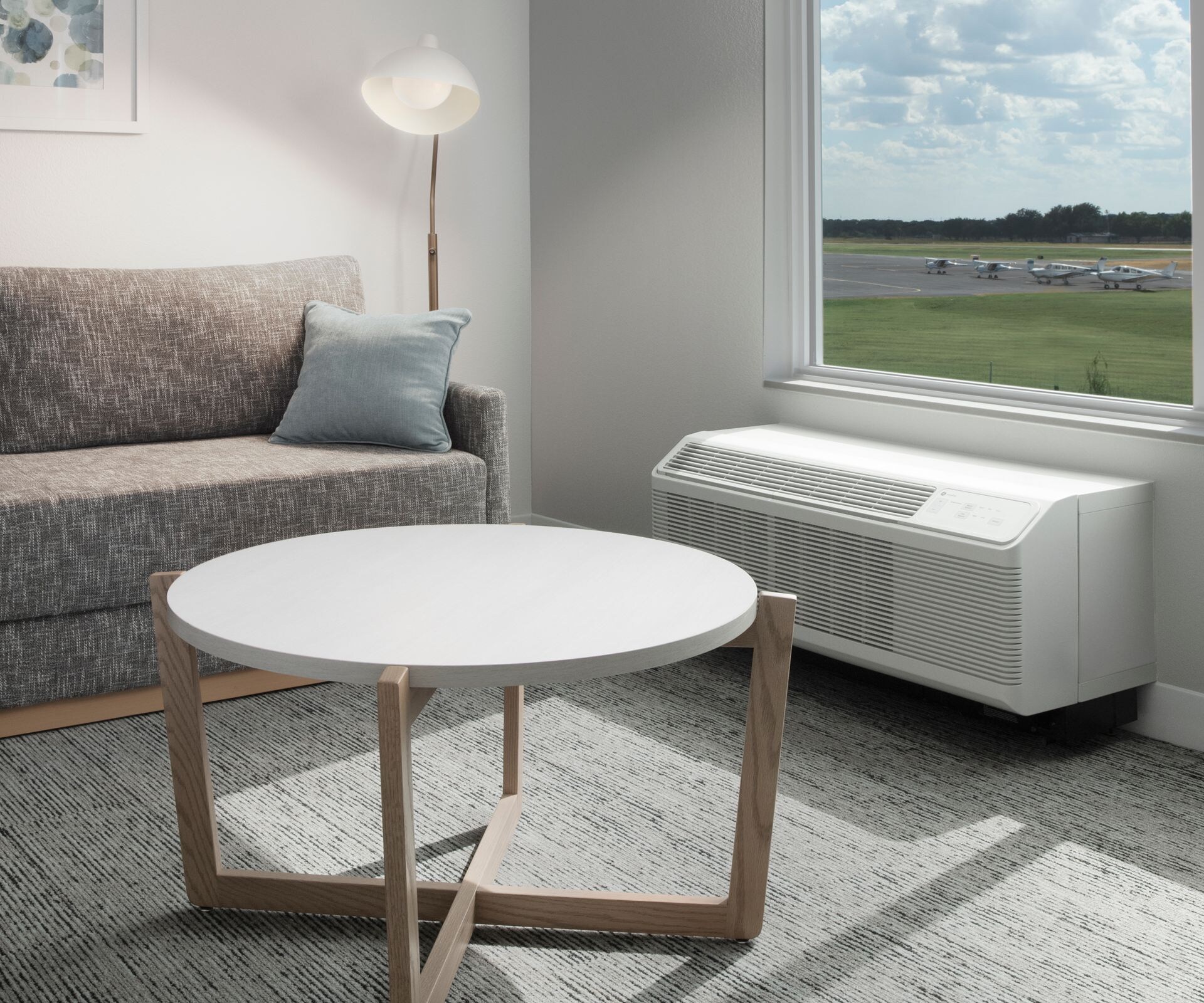 Suite living area with sofa, table & window view