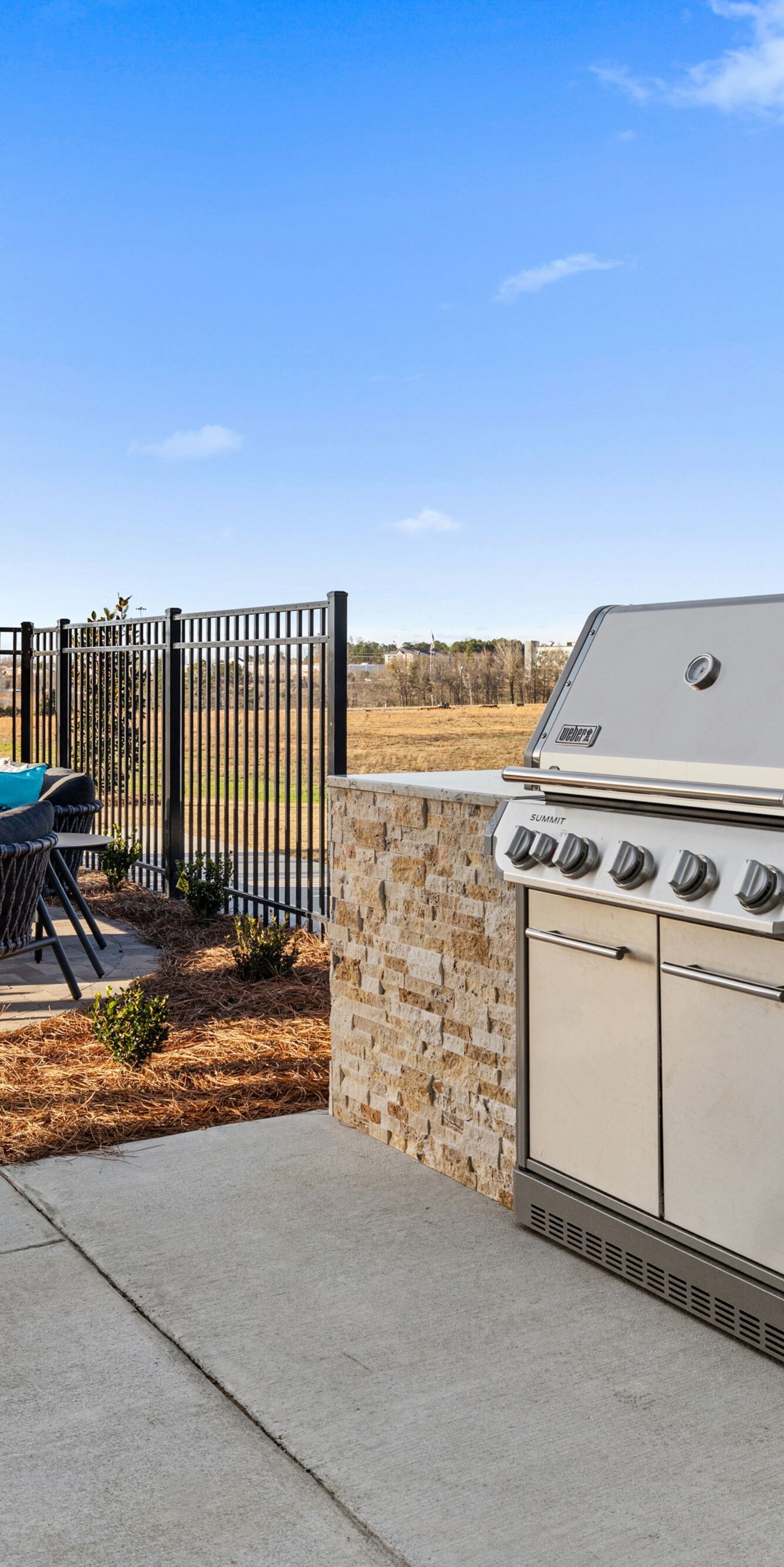 Outdoor patio with grill and seating area