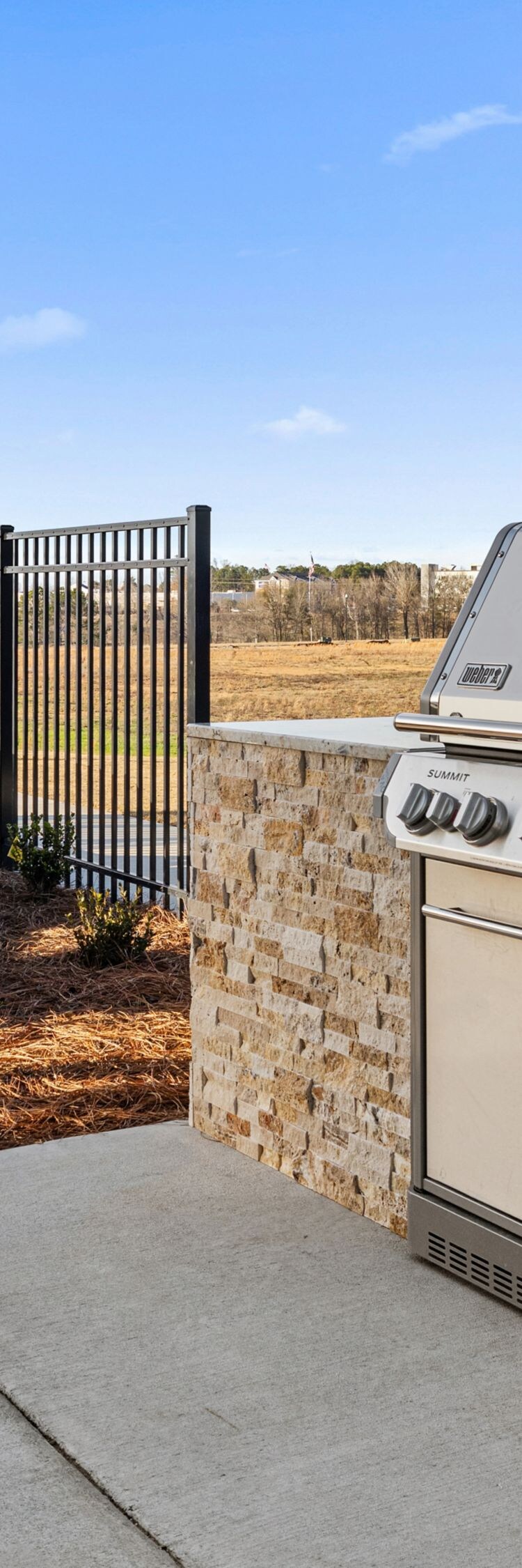 Outdoor patio with grill and seating area