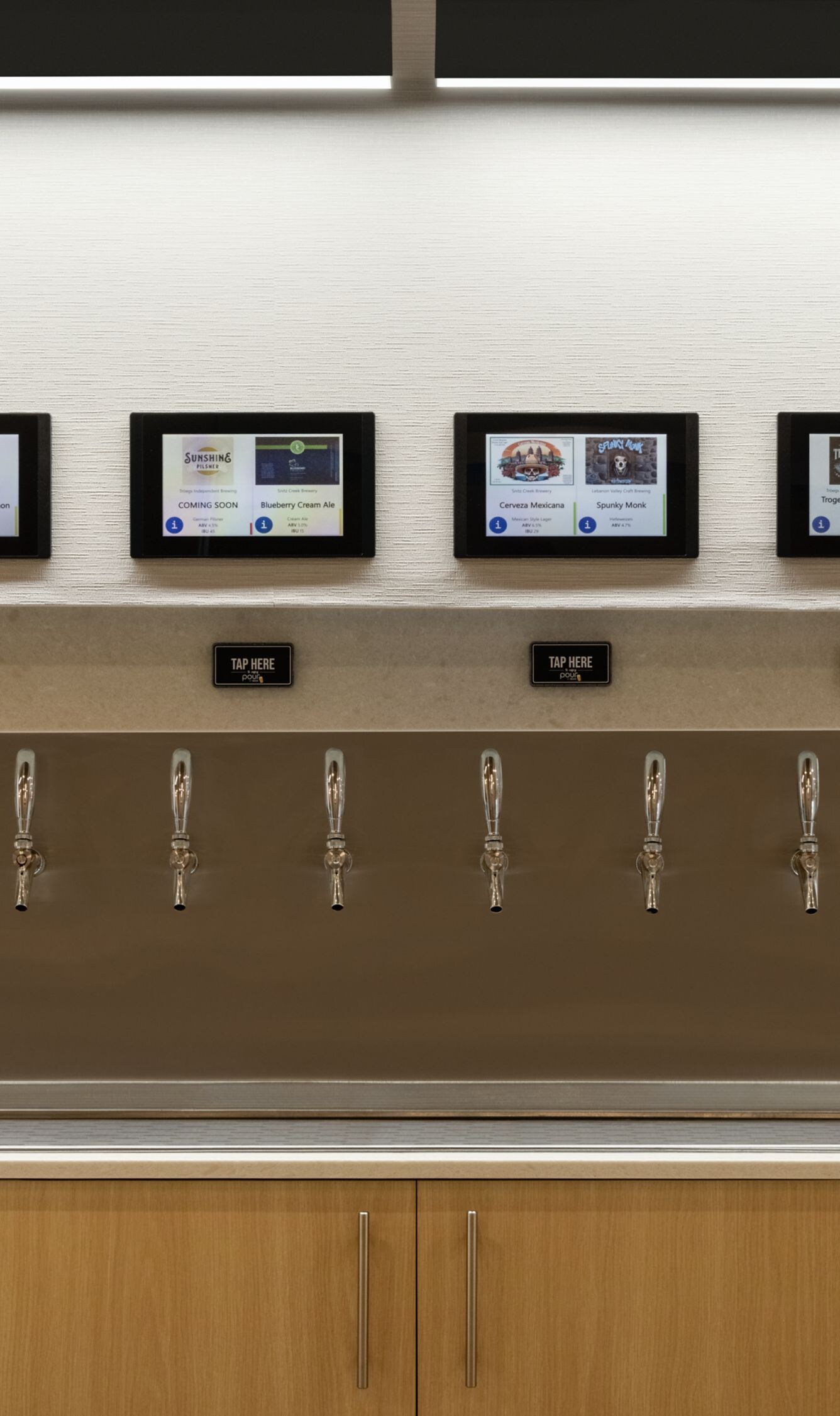 beer taps on wall in lobby with local beers
