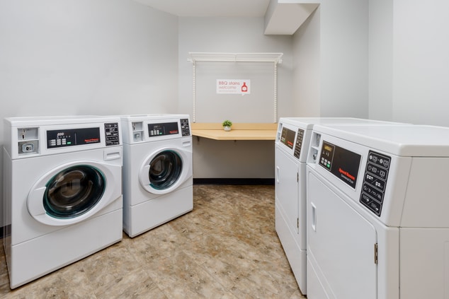 Washer and dryers in laundry room for guests