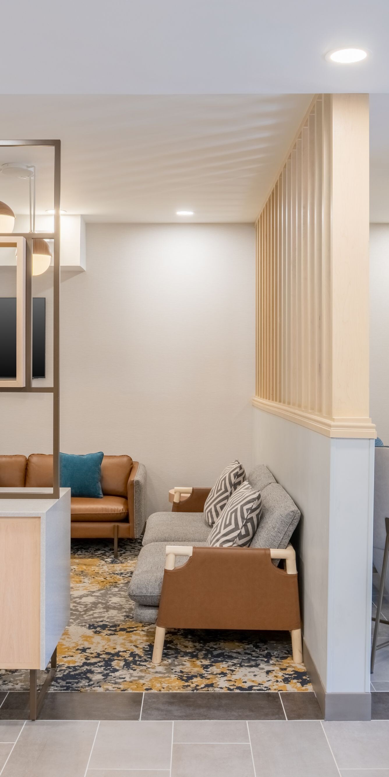 Lobby seating area with coffee tables and a TV