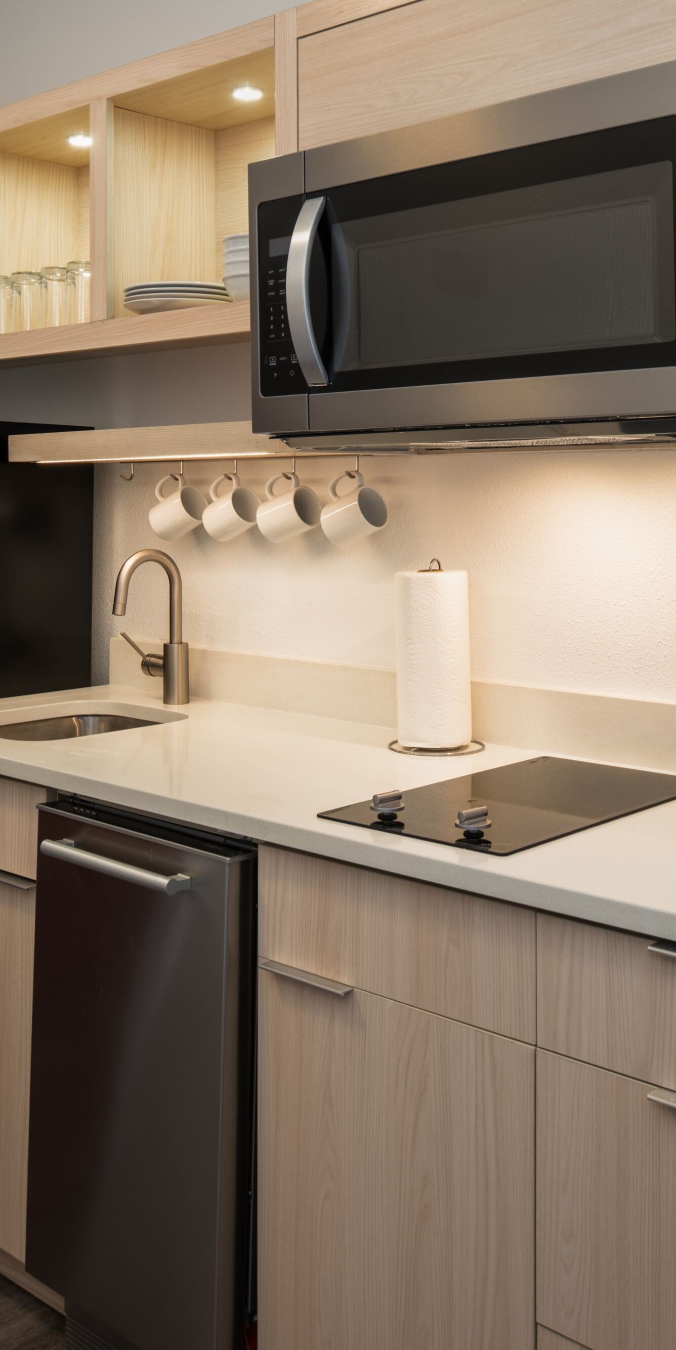 Kitchen with dishwasher, stove, microwave & fridge