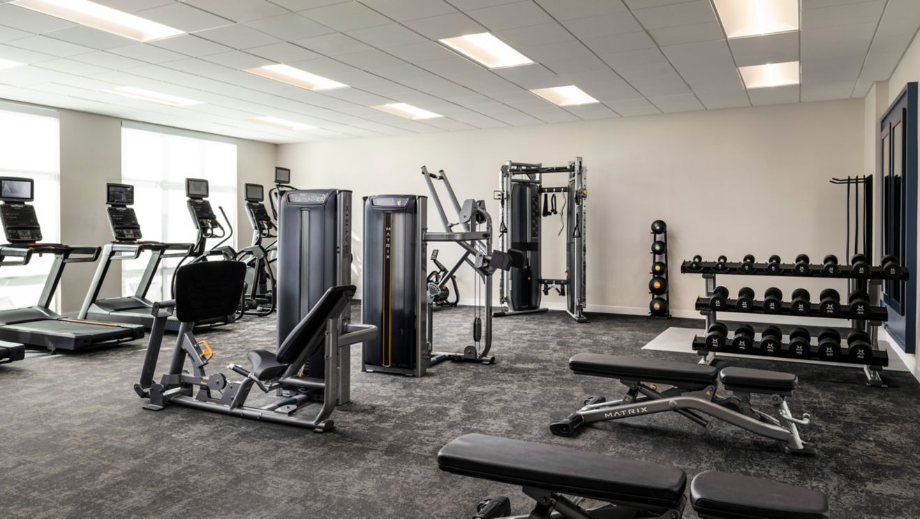 Hotel fitness center with exercise equipment.