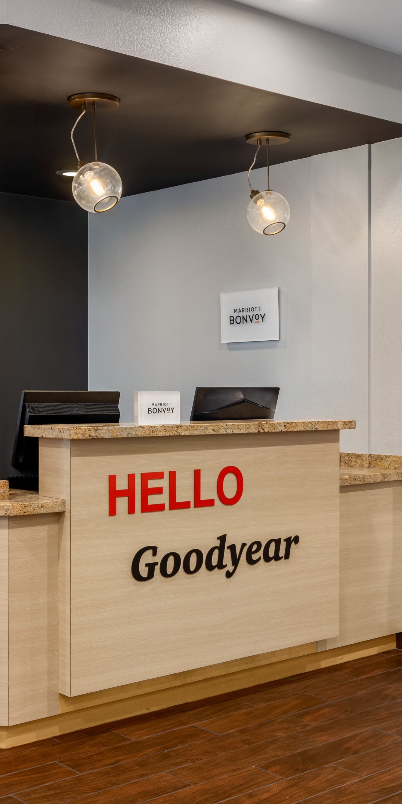 Hotel front desk with Hello Goodyear sign