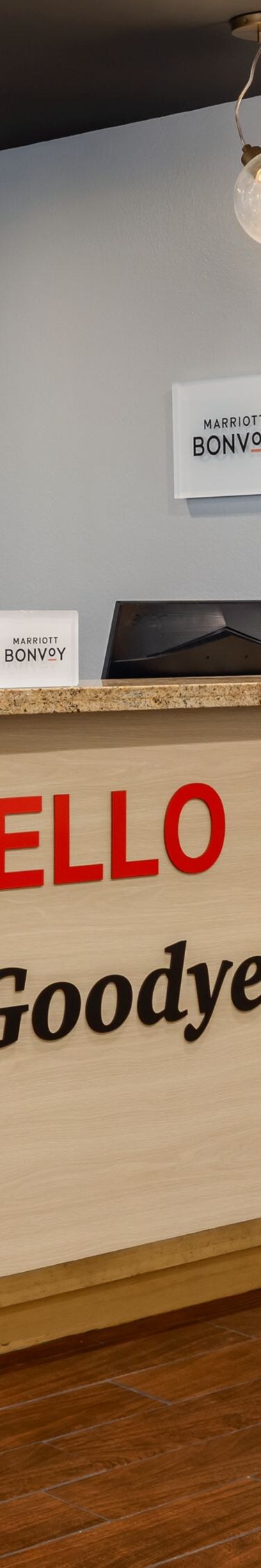 Hotel front desk with Hello Goodyear sign