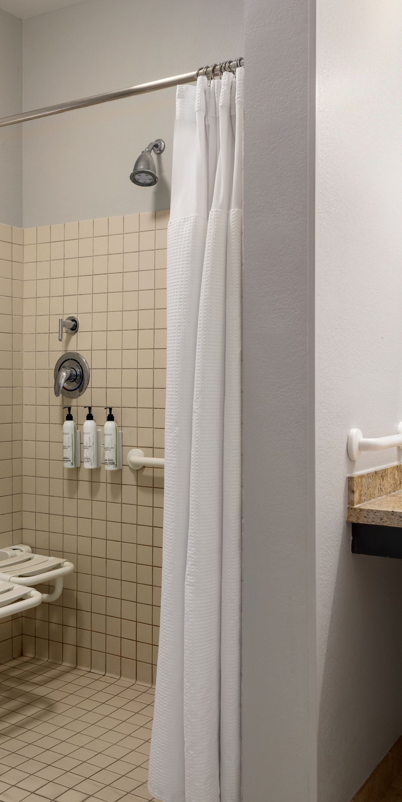 roll-in shower with seat and grab bar