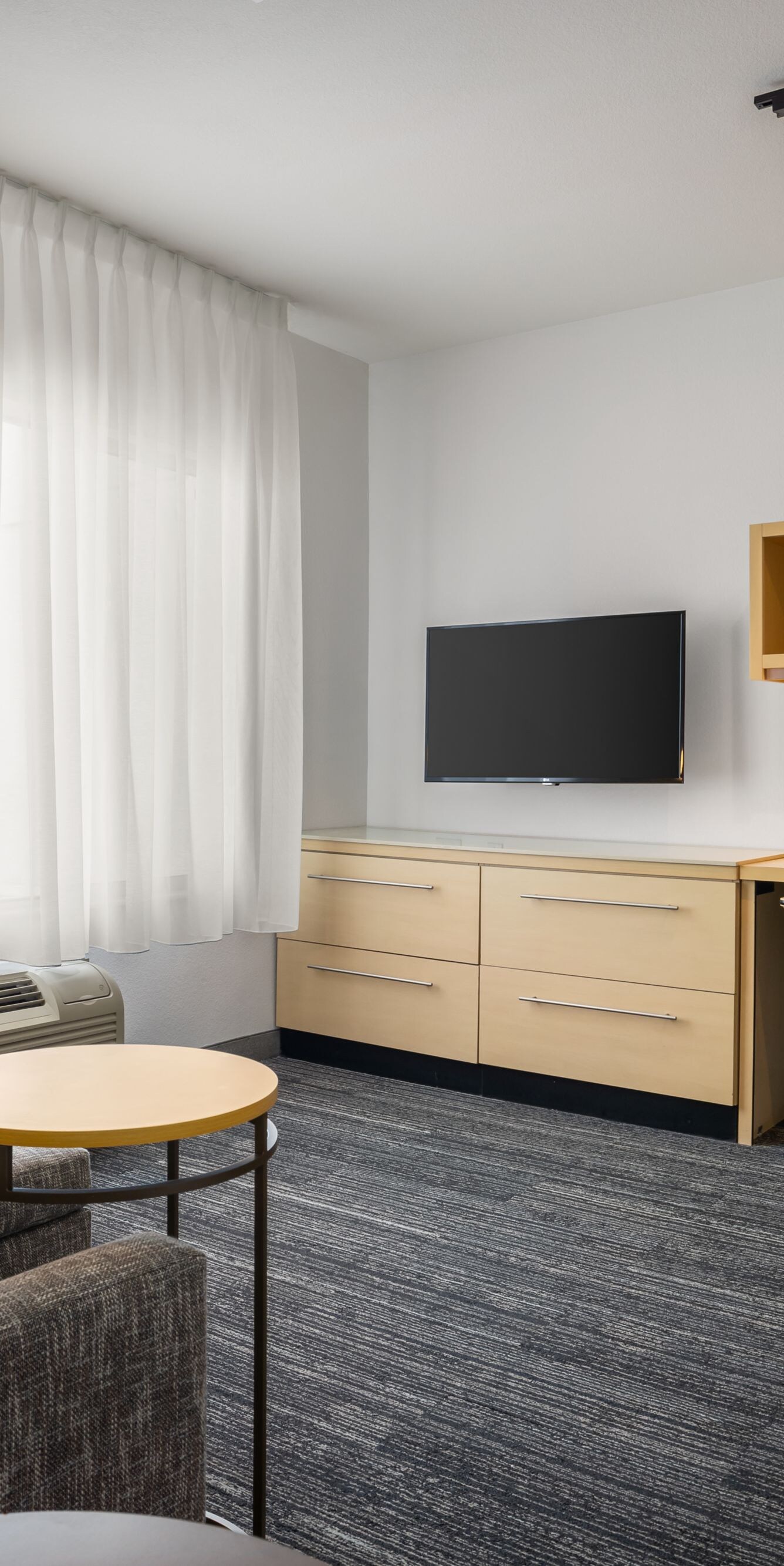couch, desk with storage area, tv, dresser