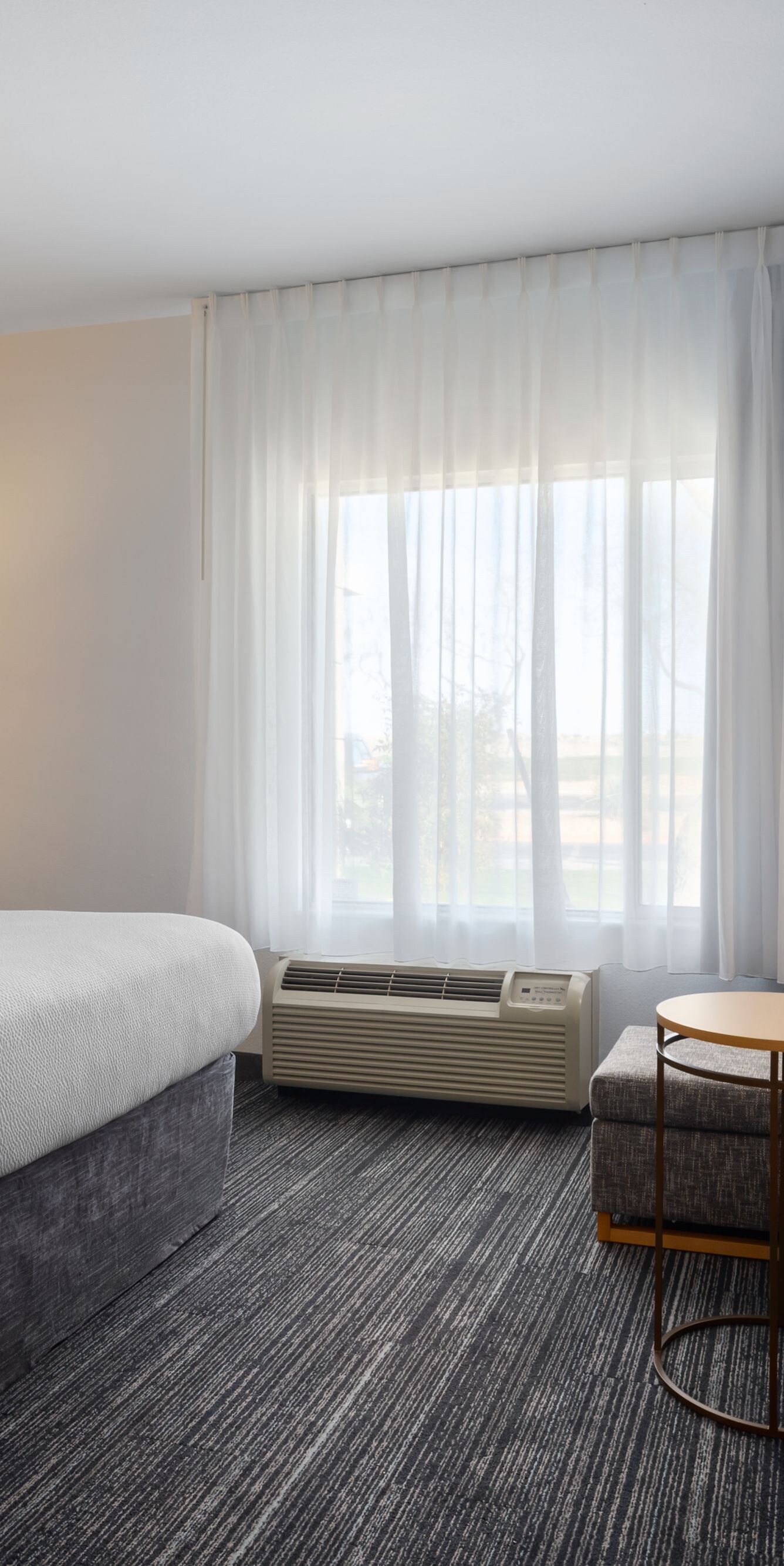 Hotel room with bed, sofa, desk and window