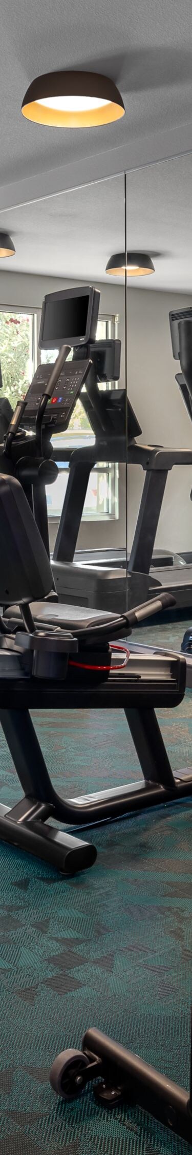 Hotel fitness room with cardio machines and weight