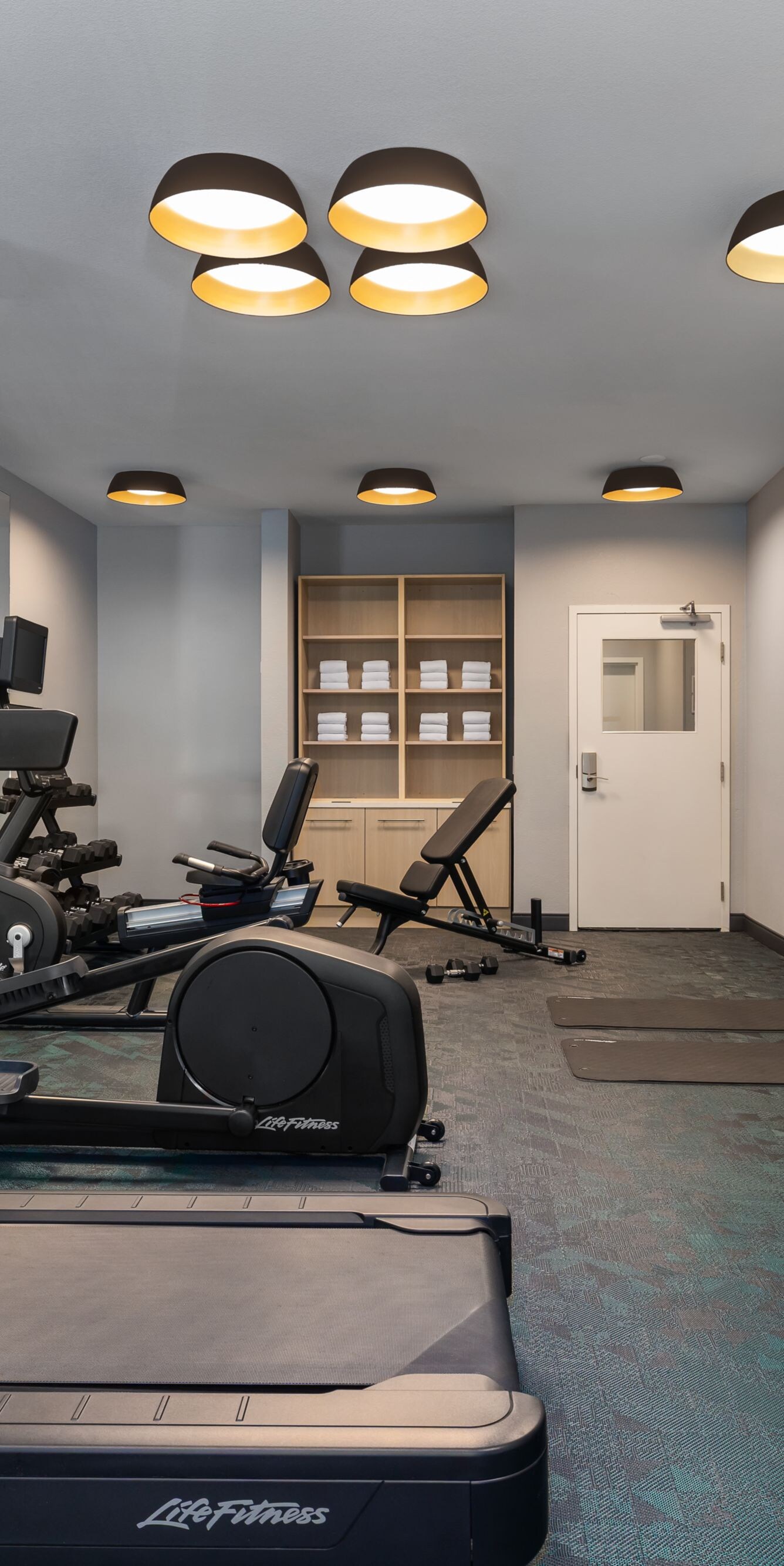 Hotel fitness room with cardio and weights