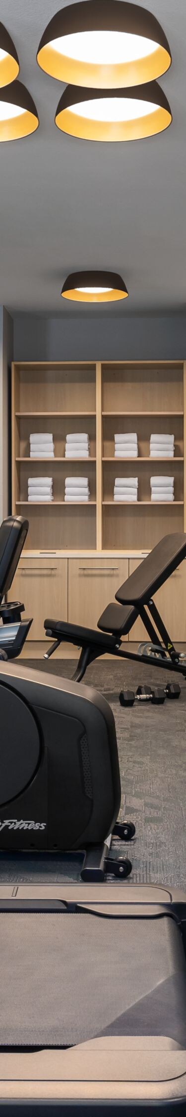 Hotel fitness room with cardio and weights