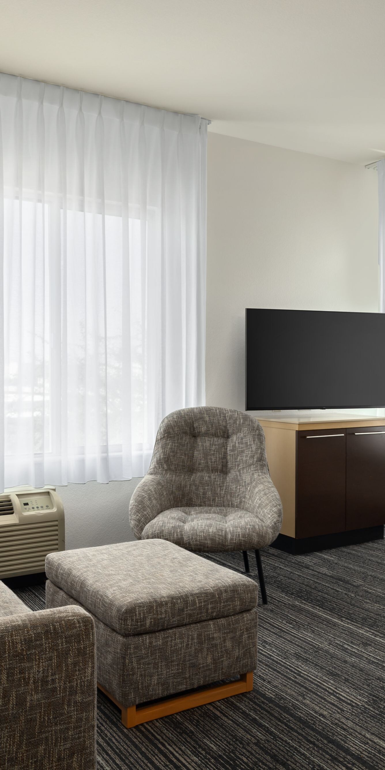 couch, ottoman, tv, and dining table