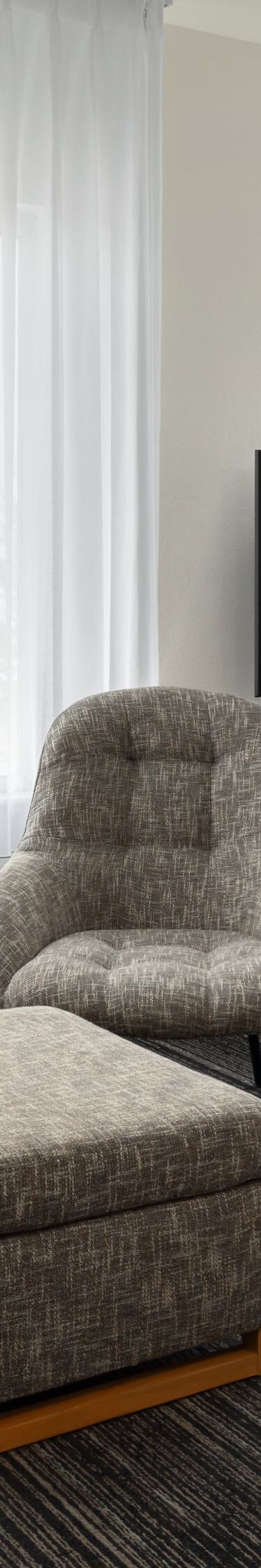 couch, ottoman, tv, and dining table