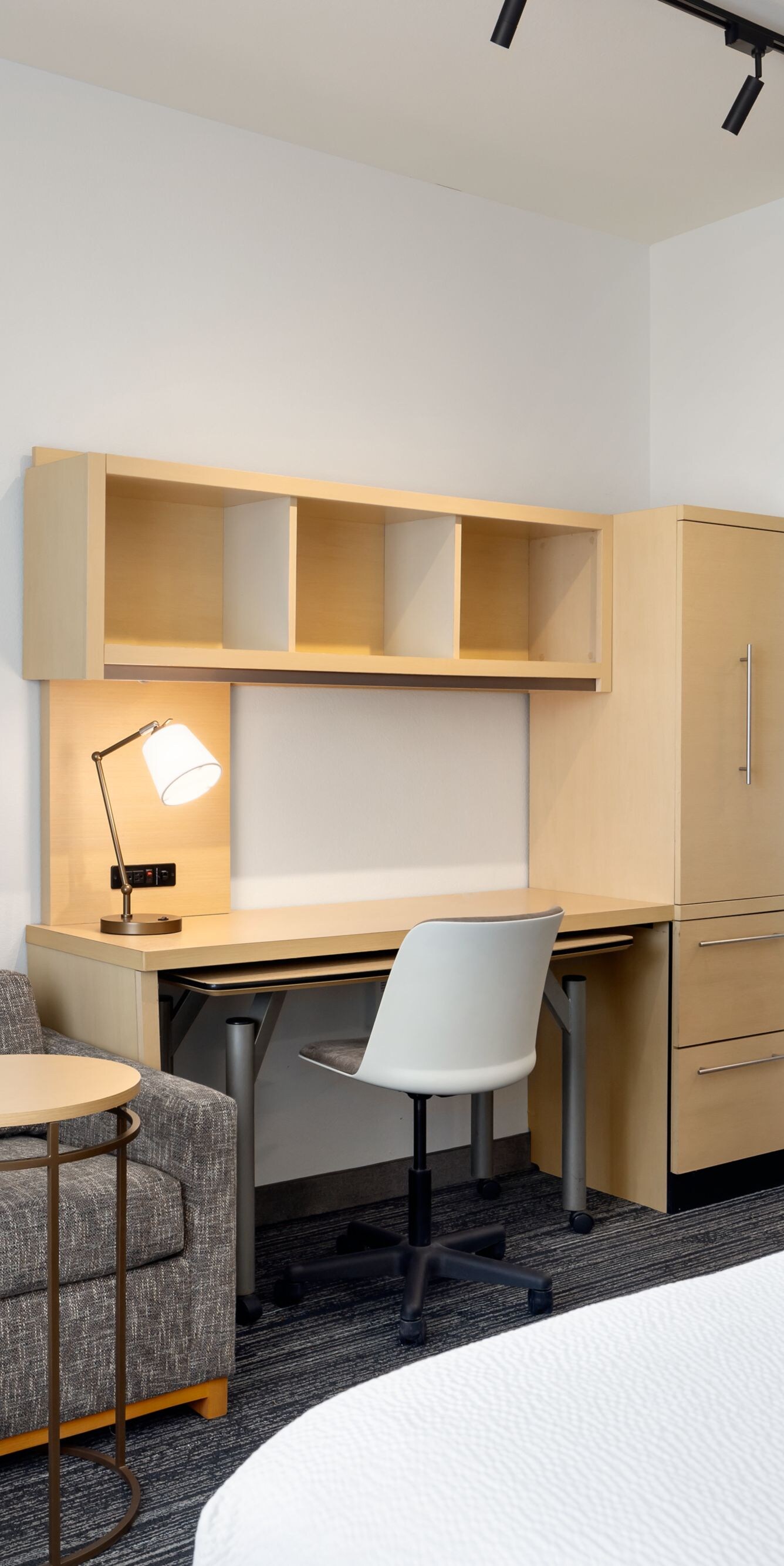 Studio hotel room with bed sofa desk and kitchen