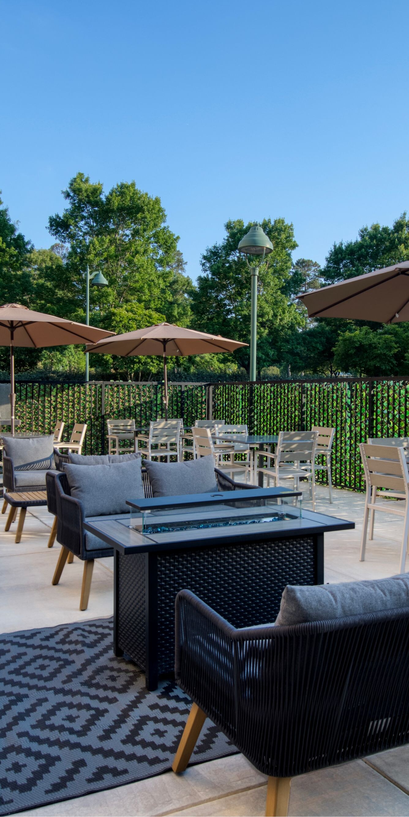 Outdoor patio with seating, tables, and umbrellas
