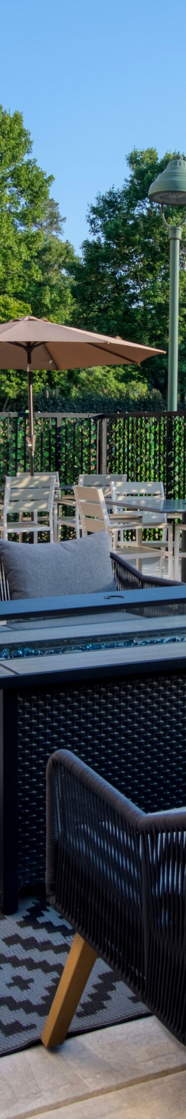 Outdoor patio with seating, tables, and umbrellas