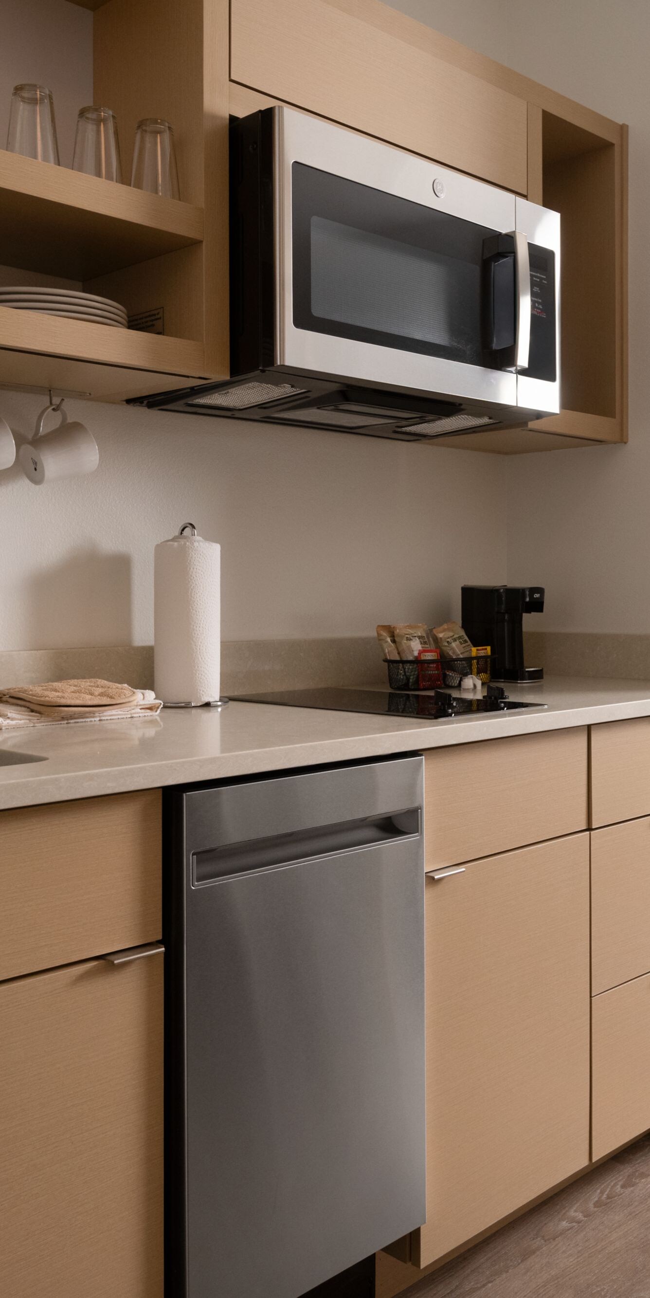 kitchenette with sink, microwave and cabinets
