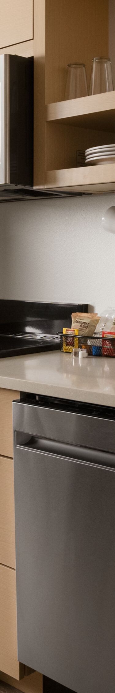 Kitchenette with dishwasher, oven, stove, and more