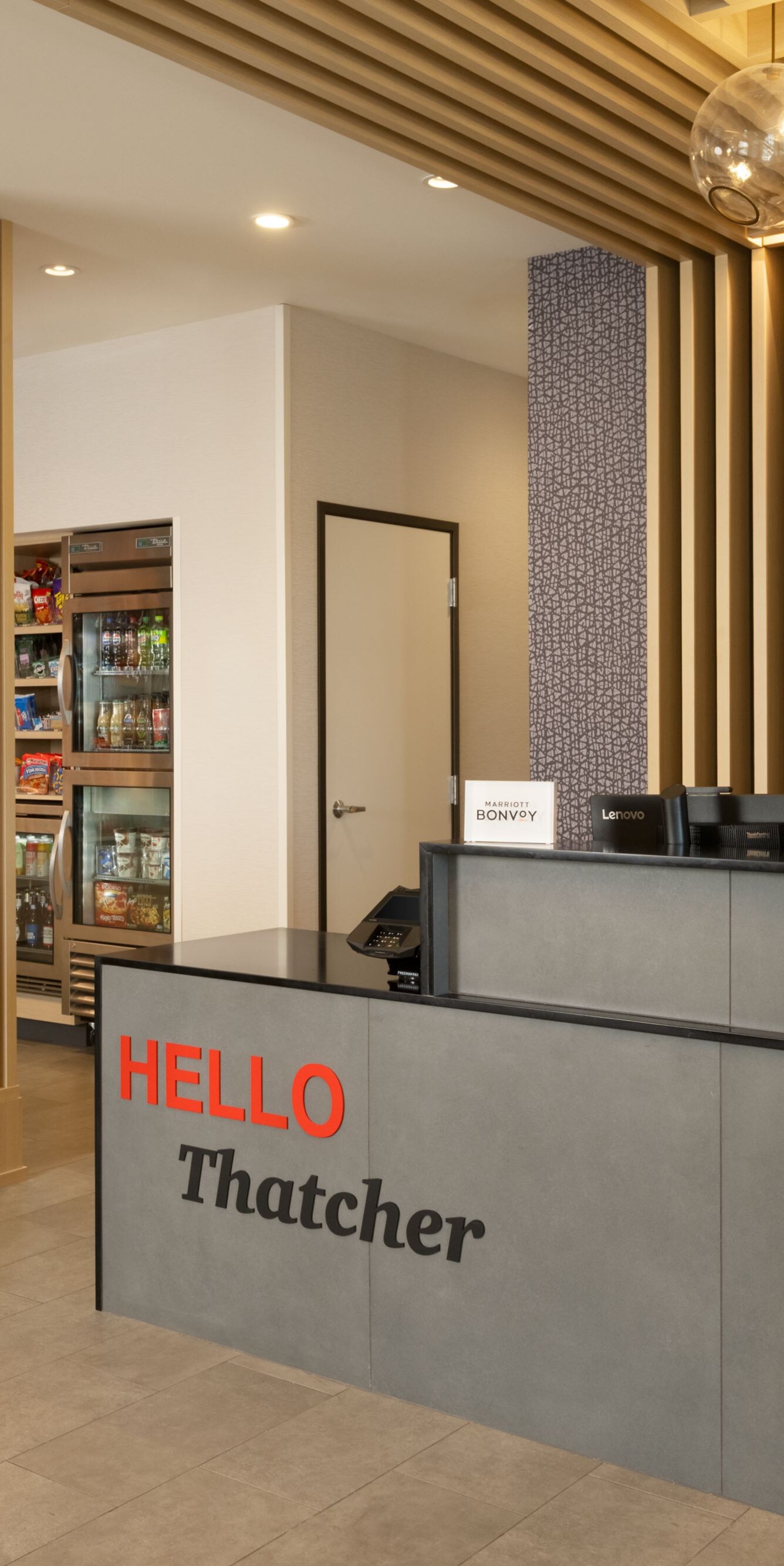 Hotel front desk with market shop and shelving