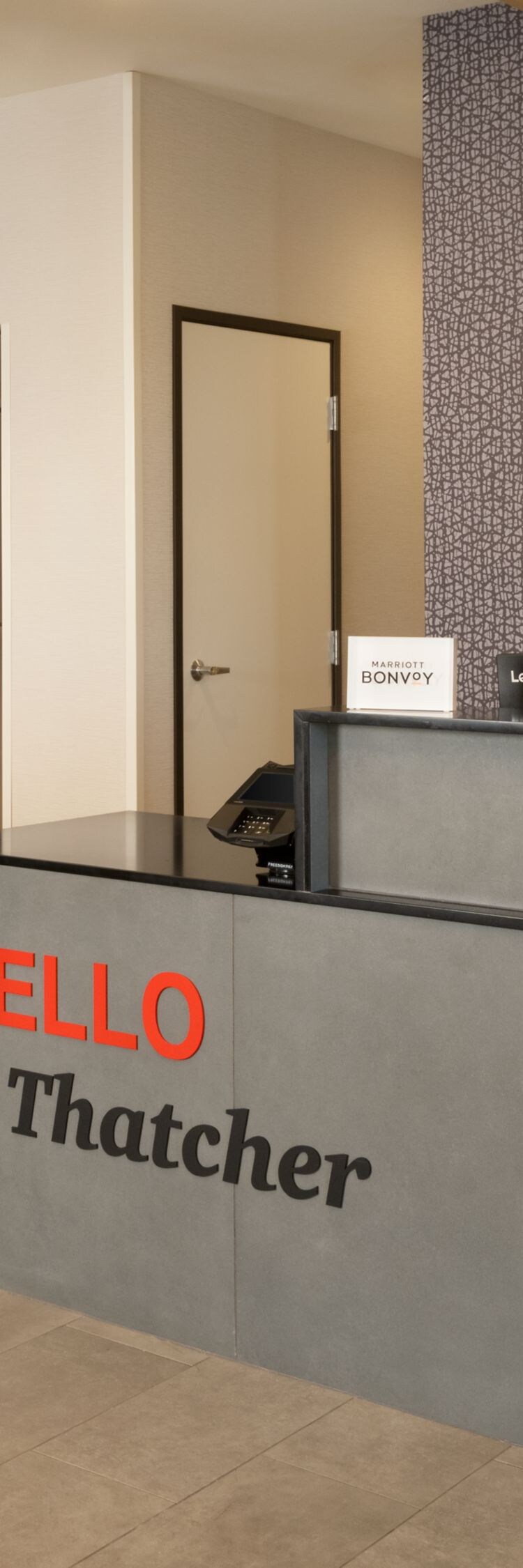 Hotel front desk with market shop and shelving