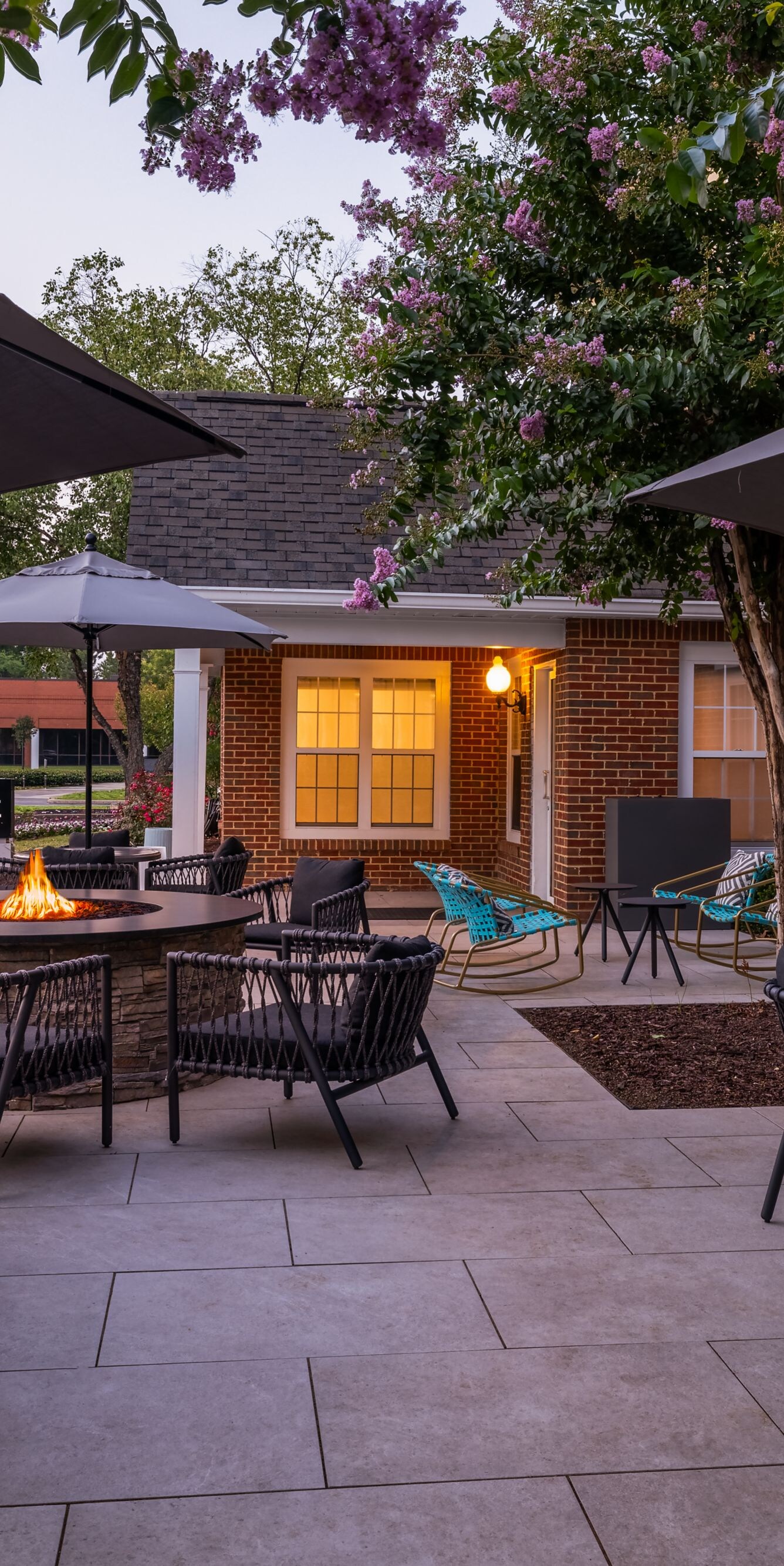 outdoor patio at dusk with seating and fire pit
