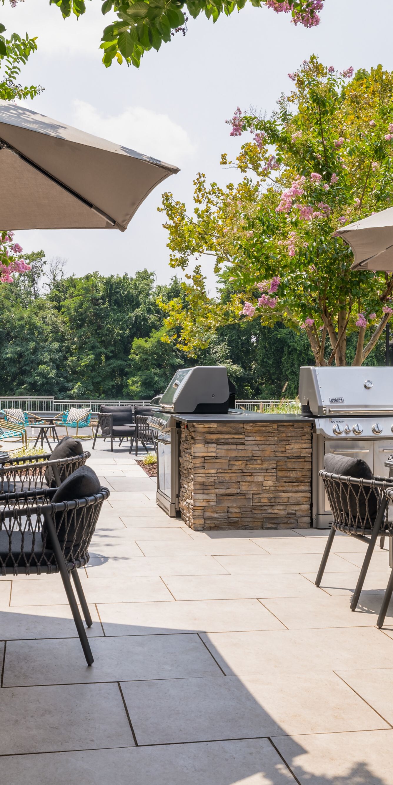 outdoor patio with table seating and weber grills