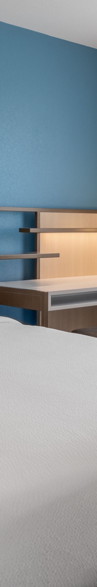 Bedroom with bed, desk, and window