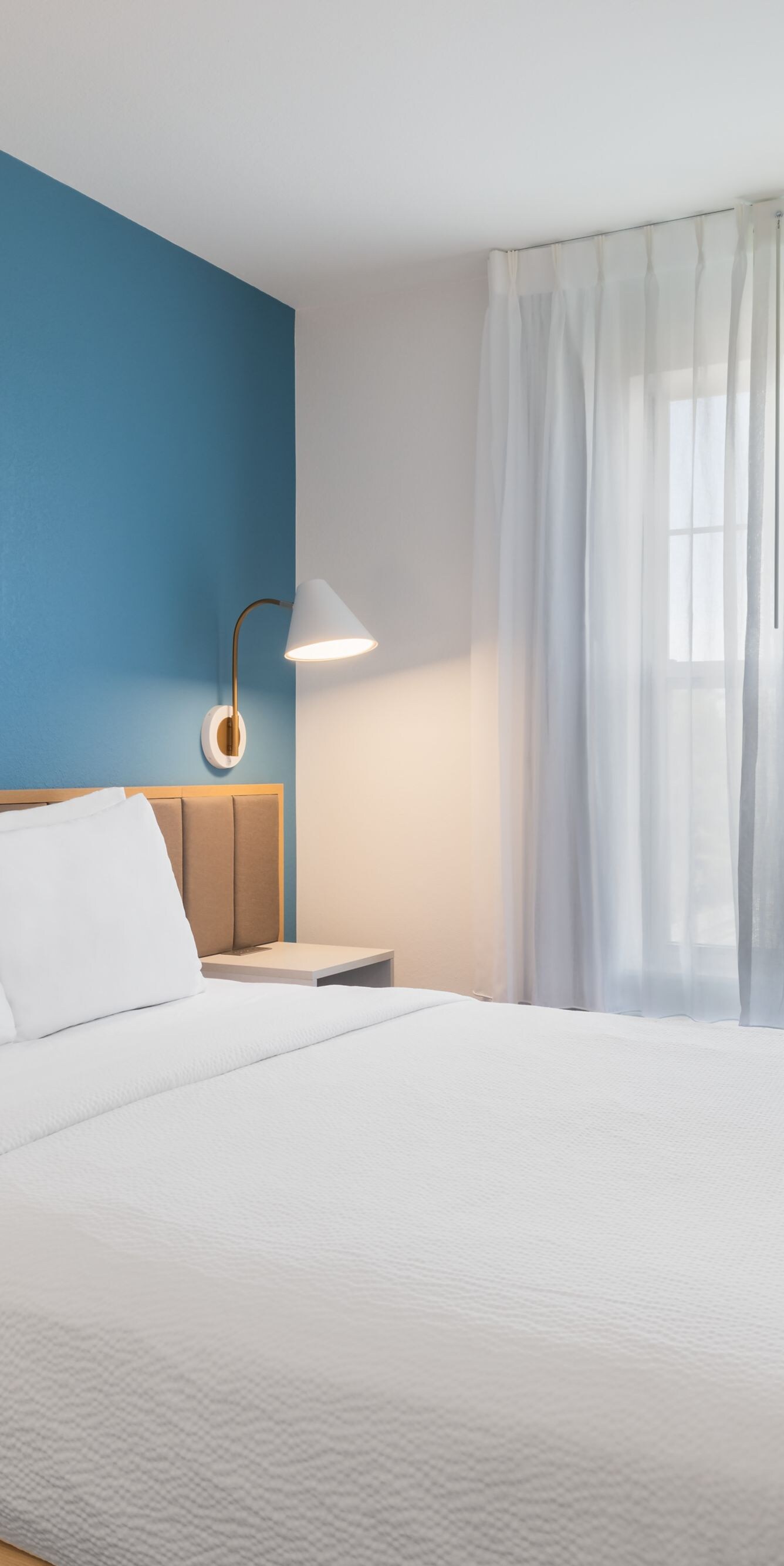 Bedroom with queen bed and window