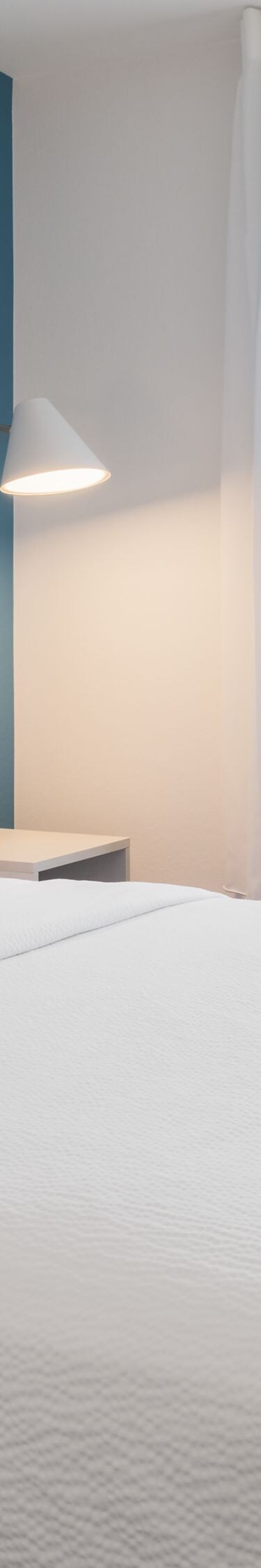 Bedroom with queen bed and window